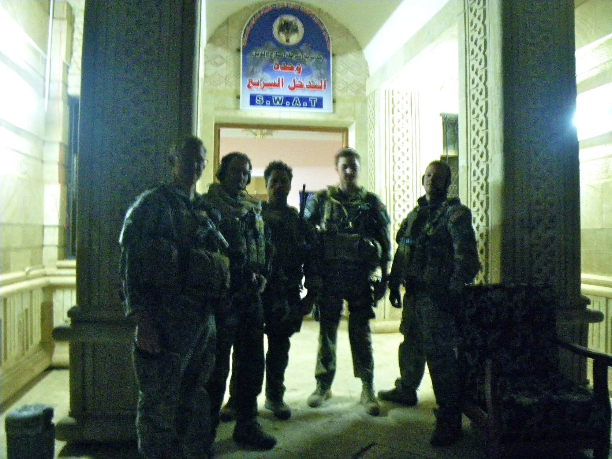 Five Special Operations veterans silhouetted in a doorway.